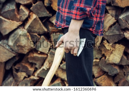 Young man holding an axe.