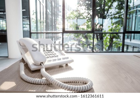 Telephone devices at modern office desk. operator phone for customer