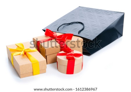 Black bag with colorful gift boxes on white background isolation