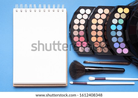 Beauty make up accessories on blue flat lay background. Make up tips template.