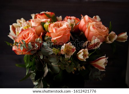 
dark luxurious bouquet of gorgeous pink roses for Valentine's day on a dark wood background