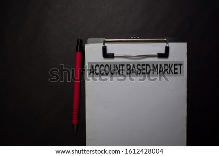 Account Based Market write on a paperwork isolated on black table.