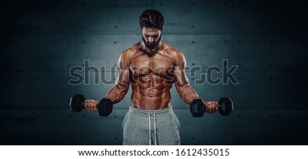 Bodybuilding Workout. Handsome Bodybuilder Training With Dumbbells. Copy Space Royalty-Free Stock Photo #1612435015