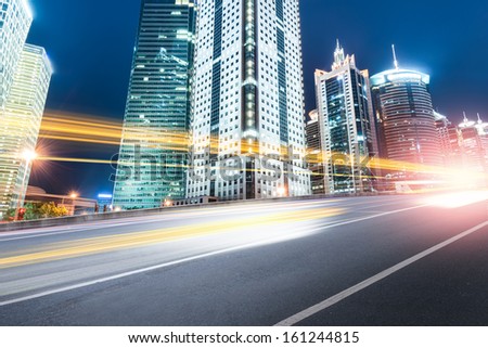The light trails on the modern building background in shanghai china.