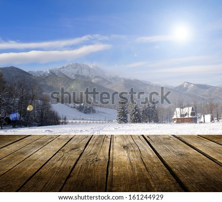 Empty wooden deck table with winter background. Ready for product display montage.