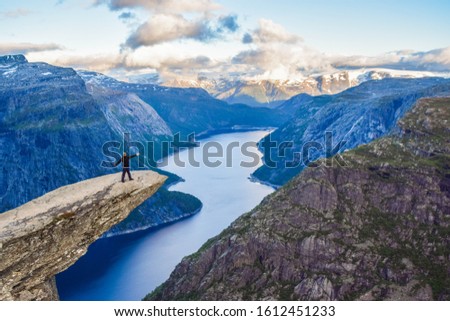 The tourist on the Trolltunga, Norway. Royalty-Free Stock Photo #1612451233