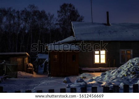 traditional Russian house in a village far from the city at night on the background of the forest