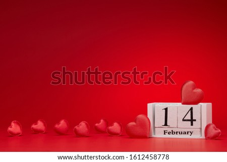 Group of silk red hearts, calendar with date 14 february on red background.  Valentine's Day card with copy space. Design element for romantic greeting card, invitation. Hearts background.