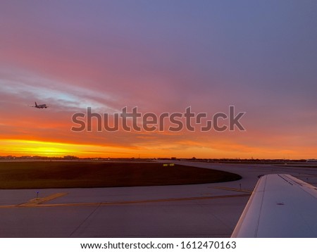 Beautiful golden hour sky view from plane at an airport