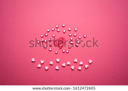 Valentines day copy space. Pink and red Heart shape beads on pink background. 