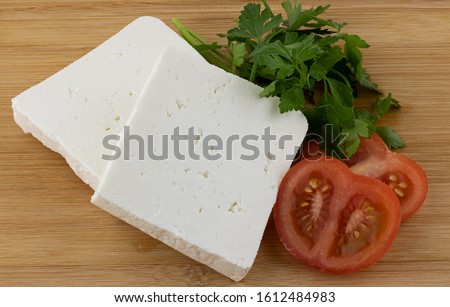 Turkish cheese known as "white cheese" with tomatoes and 
parsley. Greek Feta cheese. Healthy appetizers. Dairy products of mediterranean cuisine. Cheese slices. Royalty-Free Stock Photo #1612484983