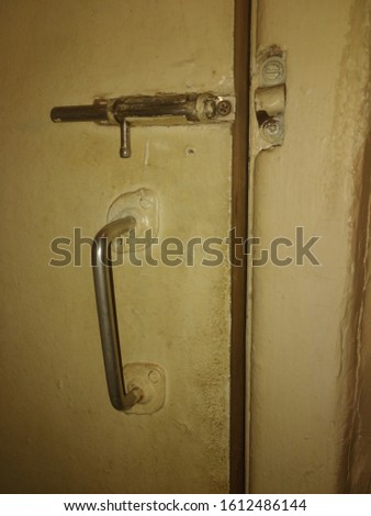 Soviet door handle and latch bolt on a dvp door in an old room