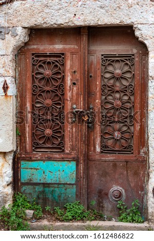 Old stone houses and colorful gates in the charming district of Foca in Izmir.