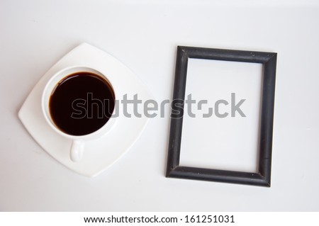 black coffee and blank frame on white background