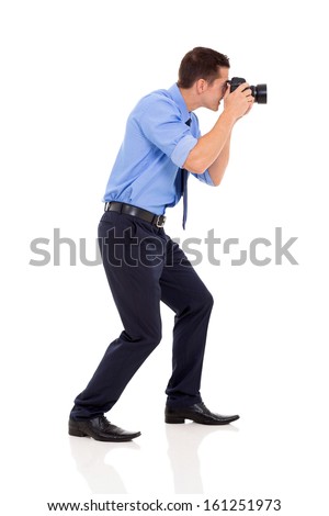 side view of male photographer taking photos on white background