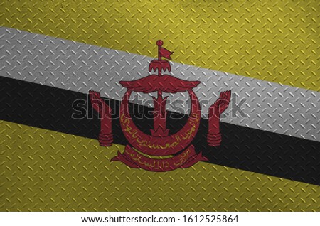 Brunei Darussalam flag depicted in paint colors on old brushed metal plate or wall closeup. Textured banner on rough background