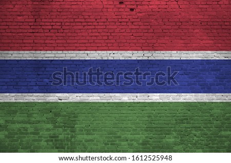 Gambia flag depicted in paint colors on old brick wall. Textured banner on big brick wall masonry background