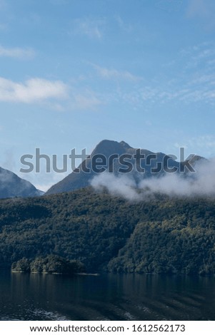 Cloudy Silhouette mountains with a blue sky 