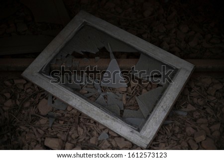 a smashed picture frame on the side of an abandoned strain track
