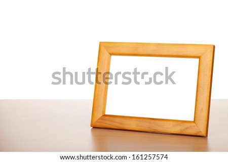 Photo frame on wood table. Isolated on white background