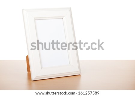 Photo frame on wood table. Isolated on white background
