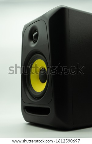 Black professional two-way active studio speaker, for music production and music mixing, isolated on a white background. Music concept.