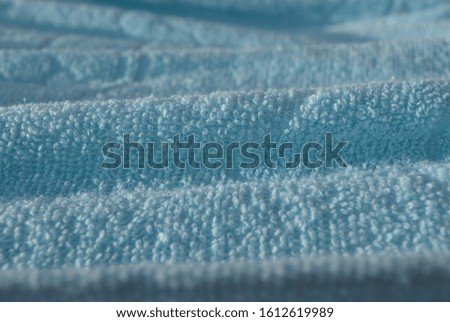 The surface of the blue fabric that is exposed to sunlight.