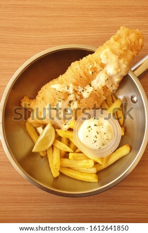 Fish and french fries with tartar sauce.
