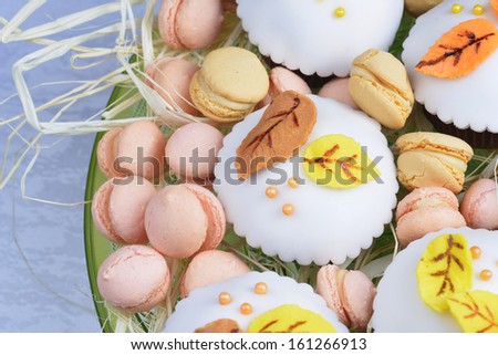 cupcakes with white icing, decorated with autumn leaves