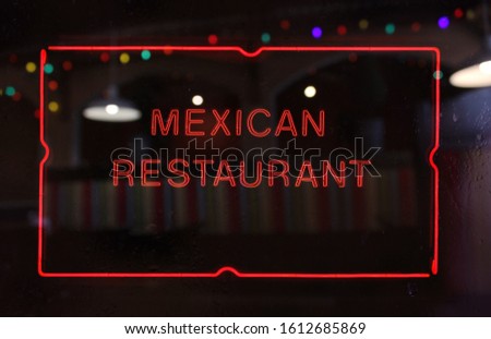 Neon Mexican Restaurant Sign in Rainy Window