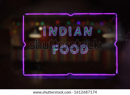 Neon Indian Food Sign in Rainy Window