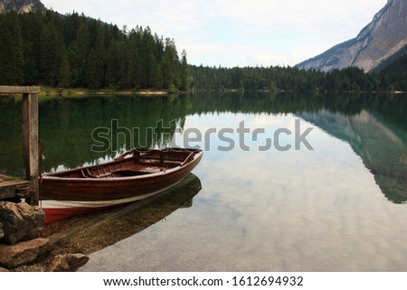 Wooden boat at the pier on the lake