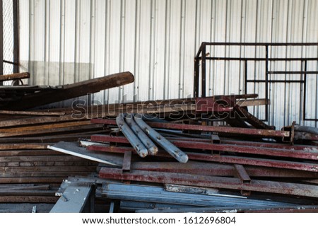 A pile of old iron and wood that has been stored in a warehouse.