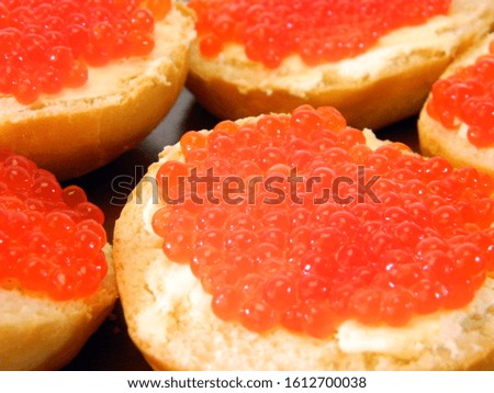 sandwich with caviar isolated on black background