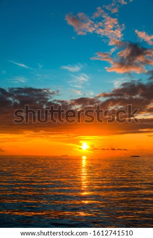 Amazing Sunset view at Indian ocean  Colorful nature scenery orange and blue shade cloudy sky, Vertical sea sunset background image