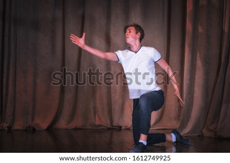 A young boy dancer rehearsing on stage, the elements of dance. The emotions in the choreography