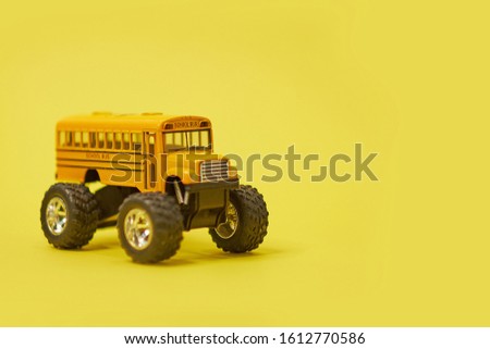 Yellow School Bus on big wheels. Transfer to school To study Safe, Soft focus and blur. And vintage style. Monster truck.