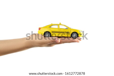 Woman with taxi car model on white background, closeup