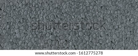 Grey styrofoam background texture closeup detail, dark foam plastic