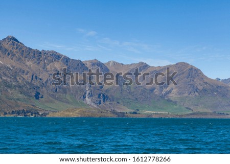 Beautiful landscape with high rocks with illuminated peaks, New Zealand.