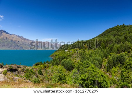 Beautiful landscape with high rocks with illuminated peaks, New Zealand.