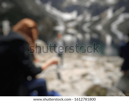 Blurred abstrack background of pond in mountains. Defocused  Morskie Oko in Poland. Visible tourists.