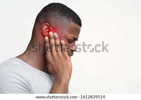 Tinnitus. Profile of sick back guy having ear pain, touching his painful head, copy space Royalty-Free Stock Photo #1612839514