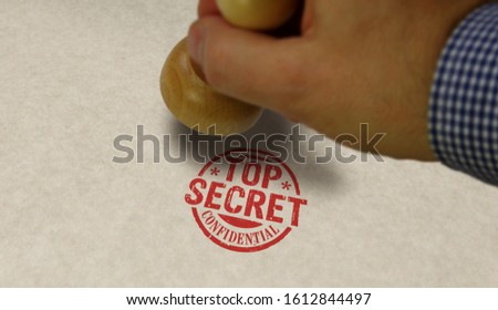 Top secret confidential stamp and stamping hand. Government, business, legal and non public document concept.