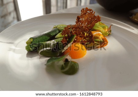 zucchini flowers with egg yolk, pistachio puree, and cheese