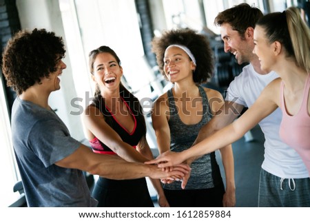 Picture of cheerful fit fitness team in gym