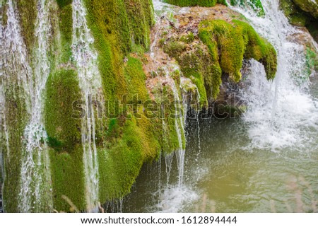 Amazing Waterfall drop down on the green moss
