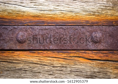 Detail of a large wooden gate with rusted iron fittings with interesting structures.