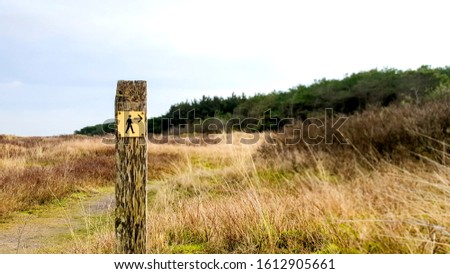 Follow the wooden signpost directions for a beautiful hike on the Dutch island Ameland in the Wadden sea
