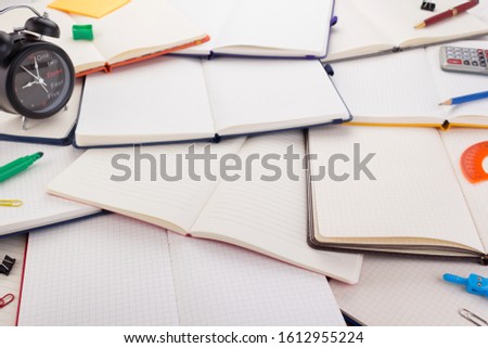 notepad or notebook with school supplies and accessories
